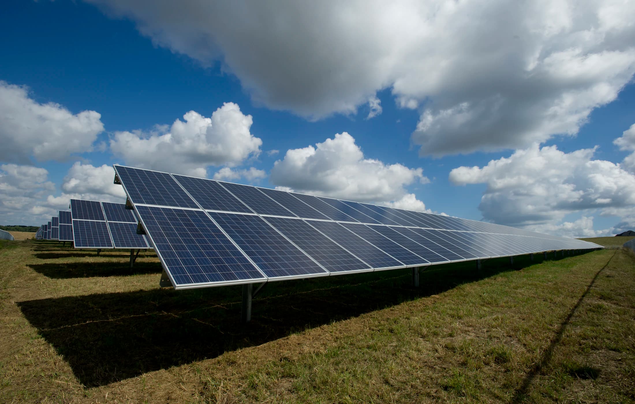 Solar panel array under a partly clouded sky